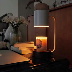 Candle warmer lamp gently melting a candle in a tranquil evening environment with books and flowers