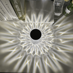 Overhead view of the Water Ripple Aurora Decorative Lamp radiating intricate crystal wave patterns across a modern white desk surface.