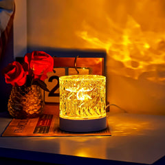 Water ripple decorative lamp illuminating a table with golden ripples, accompanied by roses and a calendar for a cozy and intimate scene.