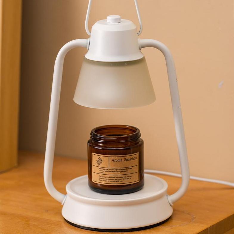 White vintage candle warmer with brown scented candle in a tranquil bedroom corner